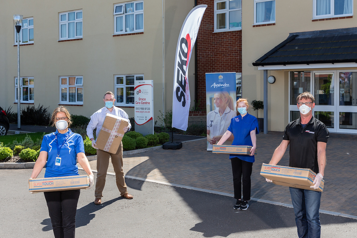April 21st 2020.

SEKO Logistics teams up with Alexandra Workwear of Thornbury, Bristol, to deliver free personal protection equipment (PPE) to the 69 homes in the Order of St John Care Trust (OSJCT) group of care homes.

Sarah Shanks (far left) of Alexandra Workwear and Dave Perry (far right) of SEKO Logistics bring boxes of PPE to care home general manager Peter Moore and carer Ella Phipps.

Photo by Tim Gander. © Tim Gander 2020. All rights reserved.